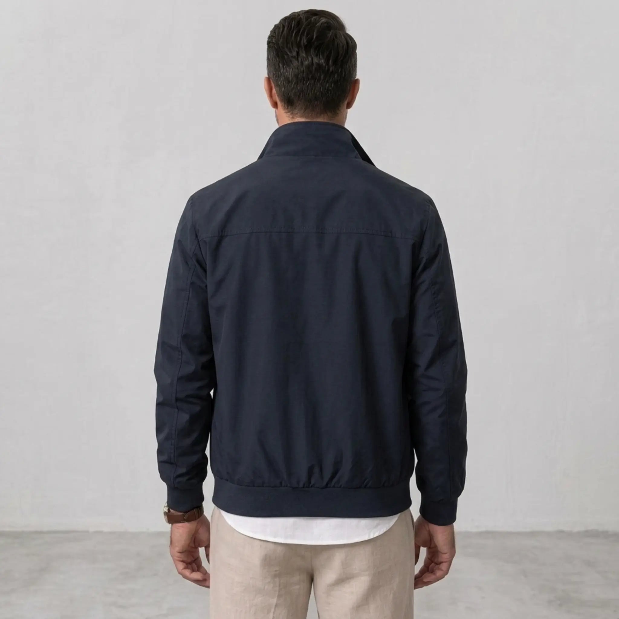 MannerCo blue solid bomber jacket back view with stand collar and ribbed hem