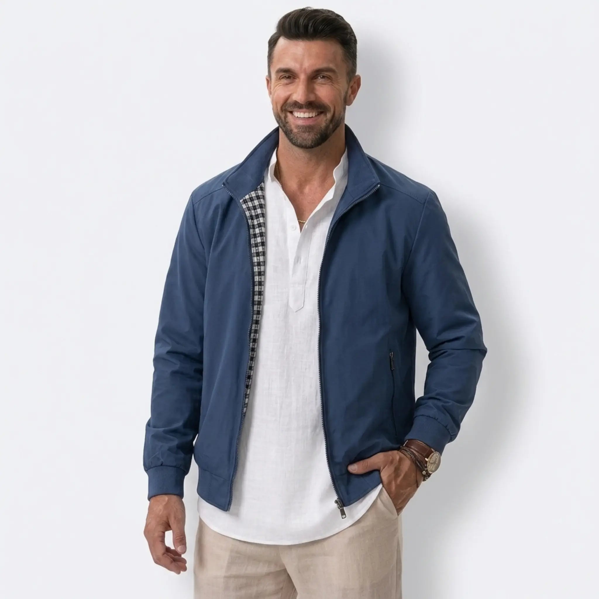 Man wearing MannerCo blue solid bomber jacket with stand collar, front view on plain background