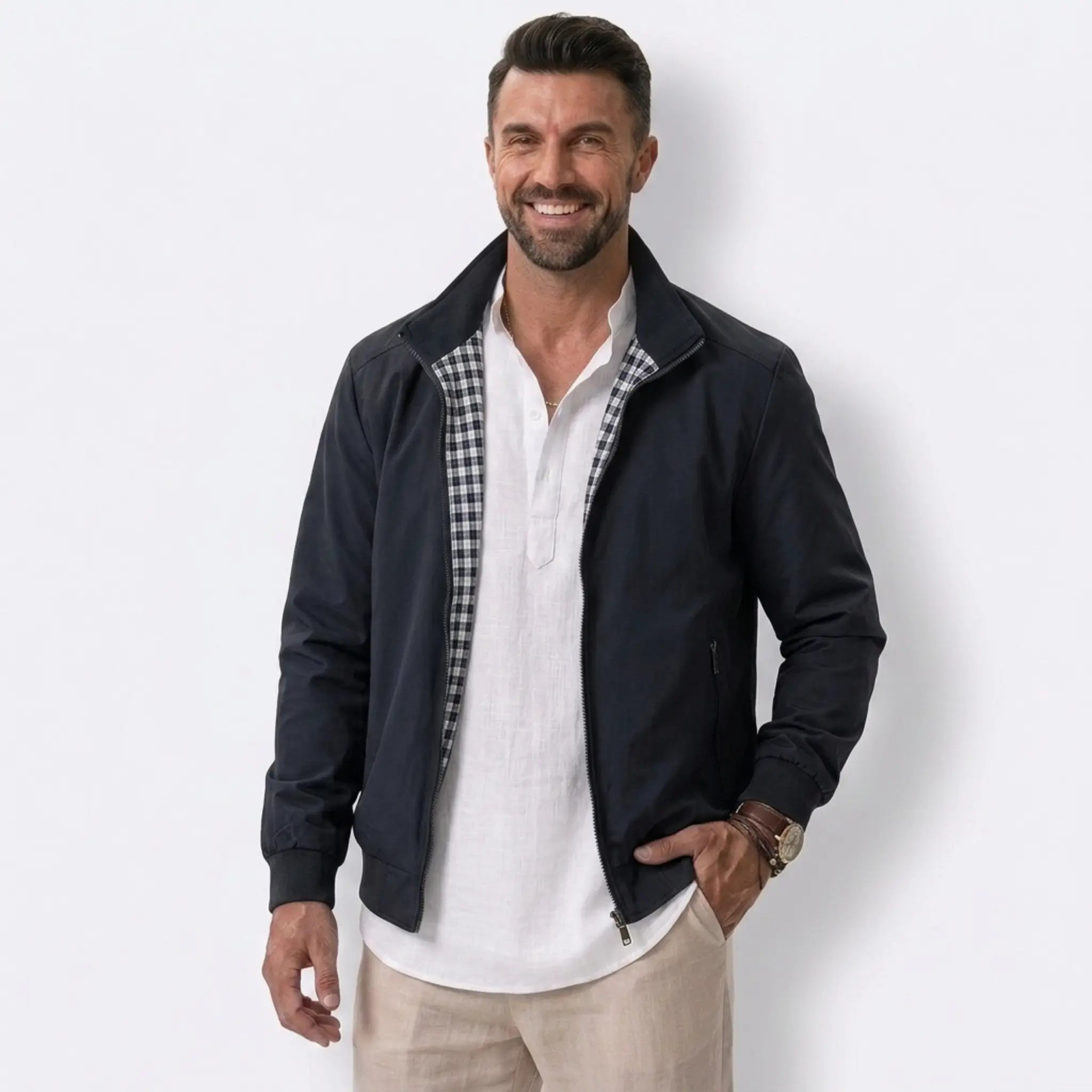 Man wearing MannerCo blue solid bomber jacket with stand collar and zip closure, front view