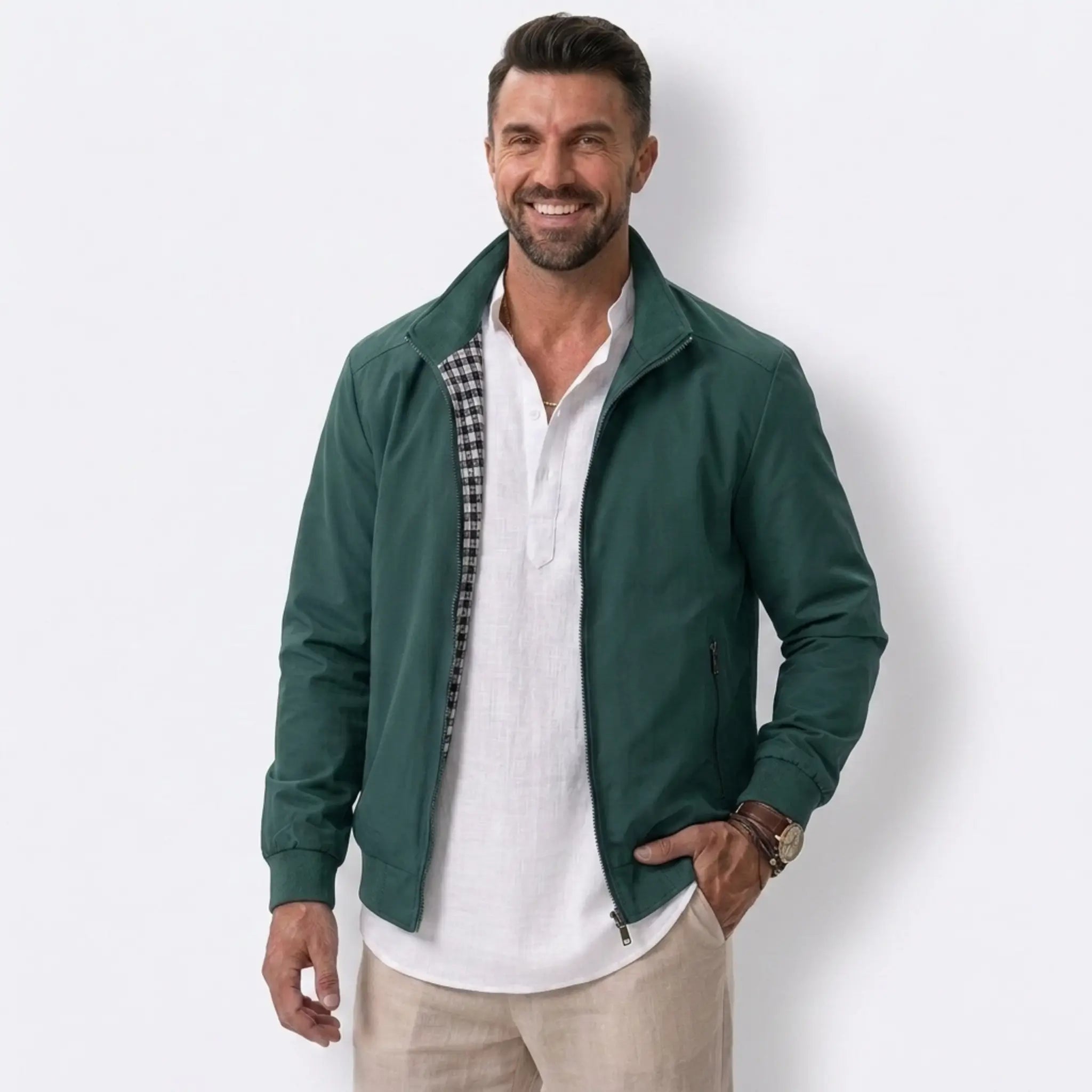 Man wearing MannerCo green solid bomber jacket with stand collar and zip closure, front view