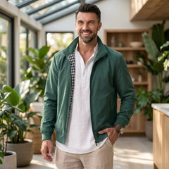 Man wearing MannerCo green solid bomber jacket in outdoor lifestyle setting