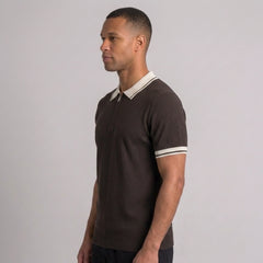 Side view of man in brown color block knit polo shirt with lapel collar
