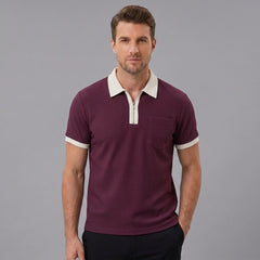 Side view of man in burgundy color block waffle polo shirt on plain background