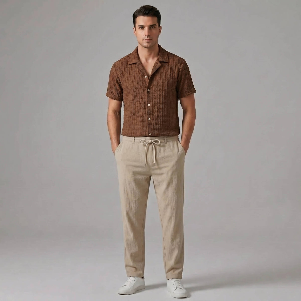 Man wearing a coffee brown jacquard Cuban collar shirt and crinkle textured straight leg pants front view