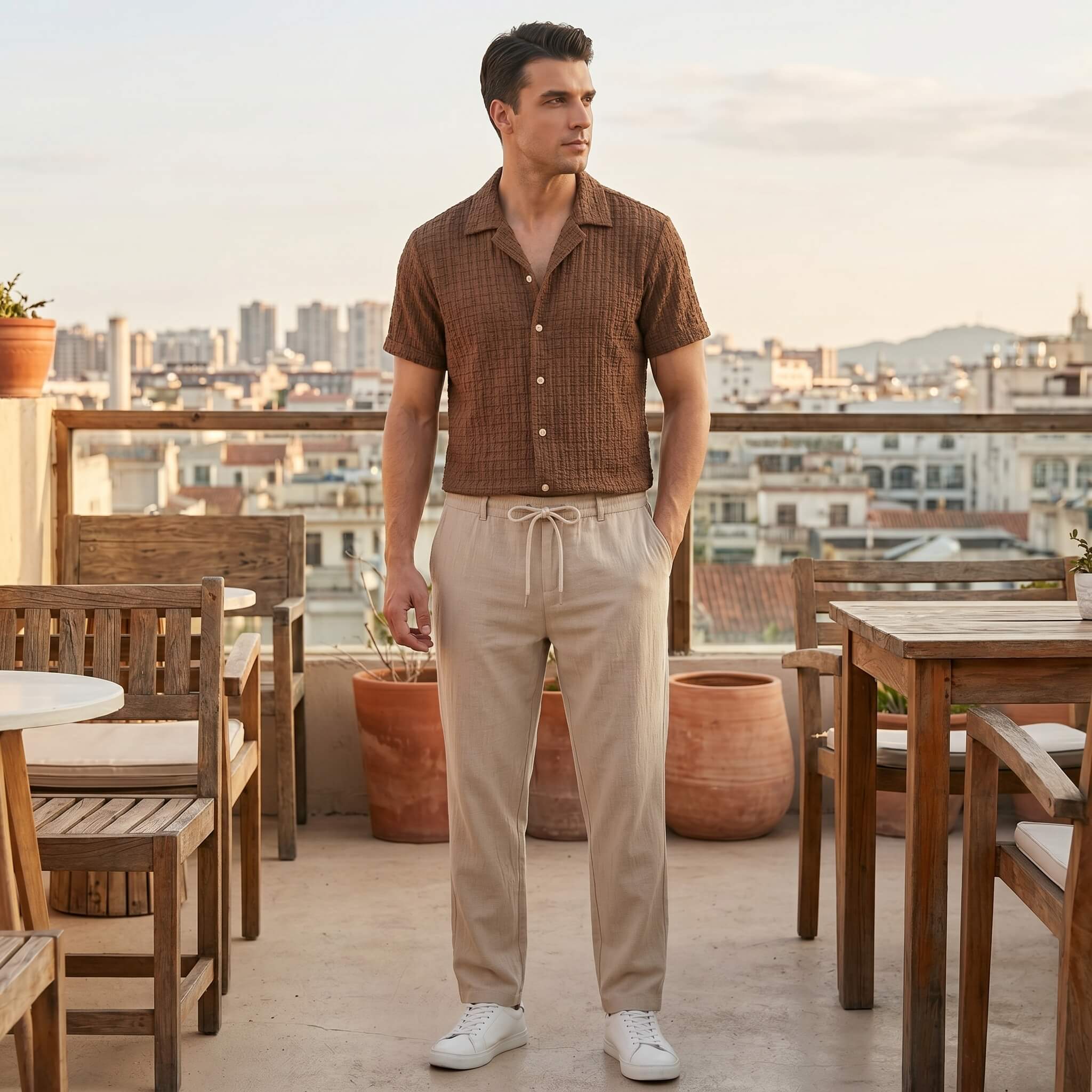 Man in coffee brown jacquard Cuban shirt and crinkle pants walking in sunny outdoor summer scene