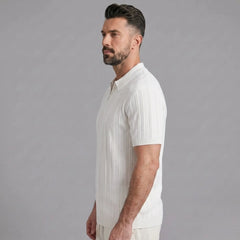 Man in coffee stripe jacquard knit zip-up polo shirt in sunny outdoor scene