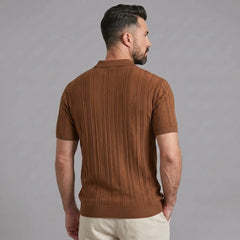 Side view of man in coffee stripe jacquard knit zip-up polo shirt on plain background