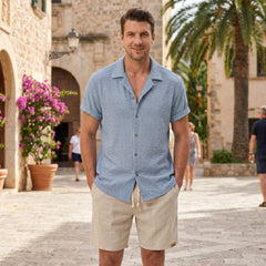 Man wearing coffee brown textured Cuban shirt and linen cotton drawstring shorts front view on plain background