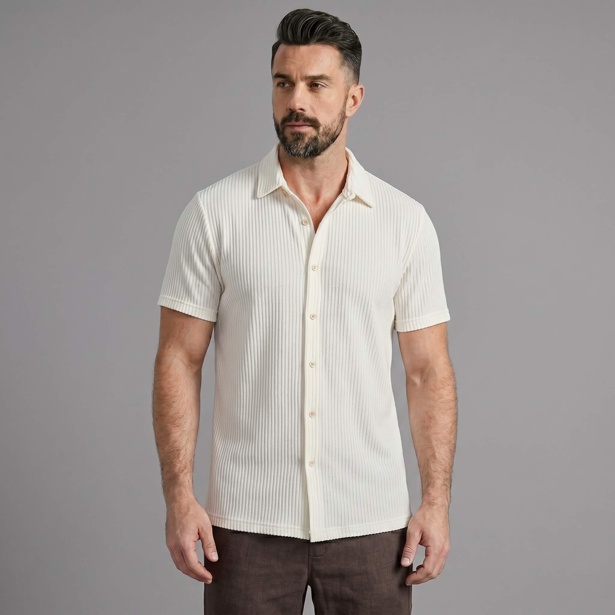 Three quarter view of man in coffee brown waffle button up shirt and linen pants