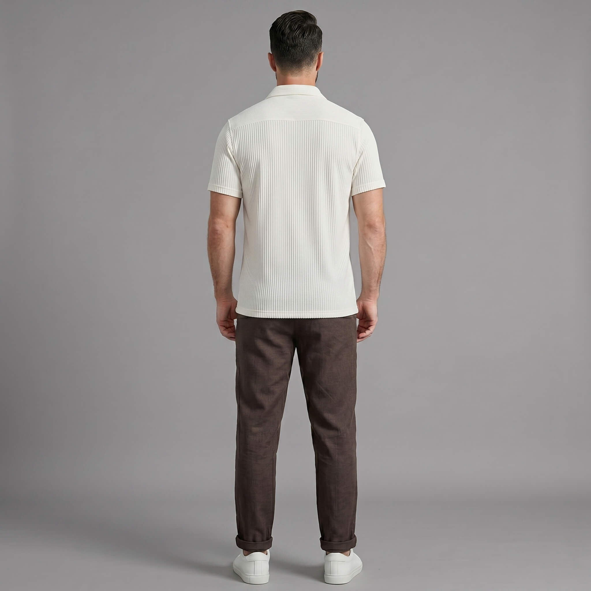 Back view of man wearing coffee brown waffle button up shirt and straight leg linen pants