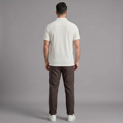 Back view of man wearing coffee brown waffle button up shirt and straight leg linen pants