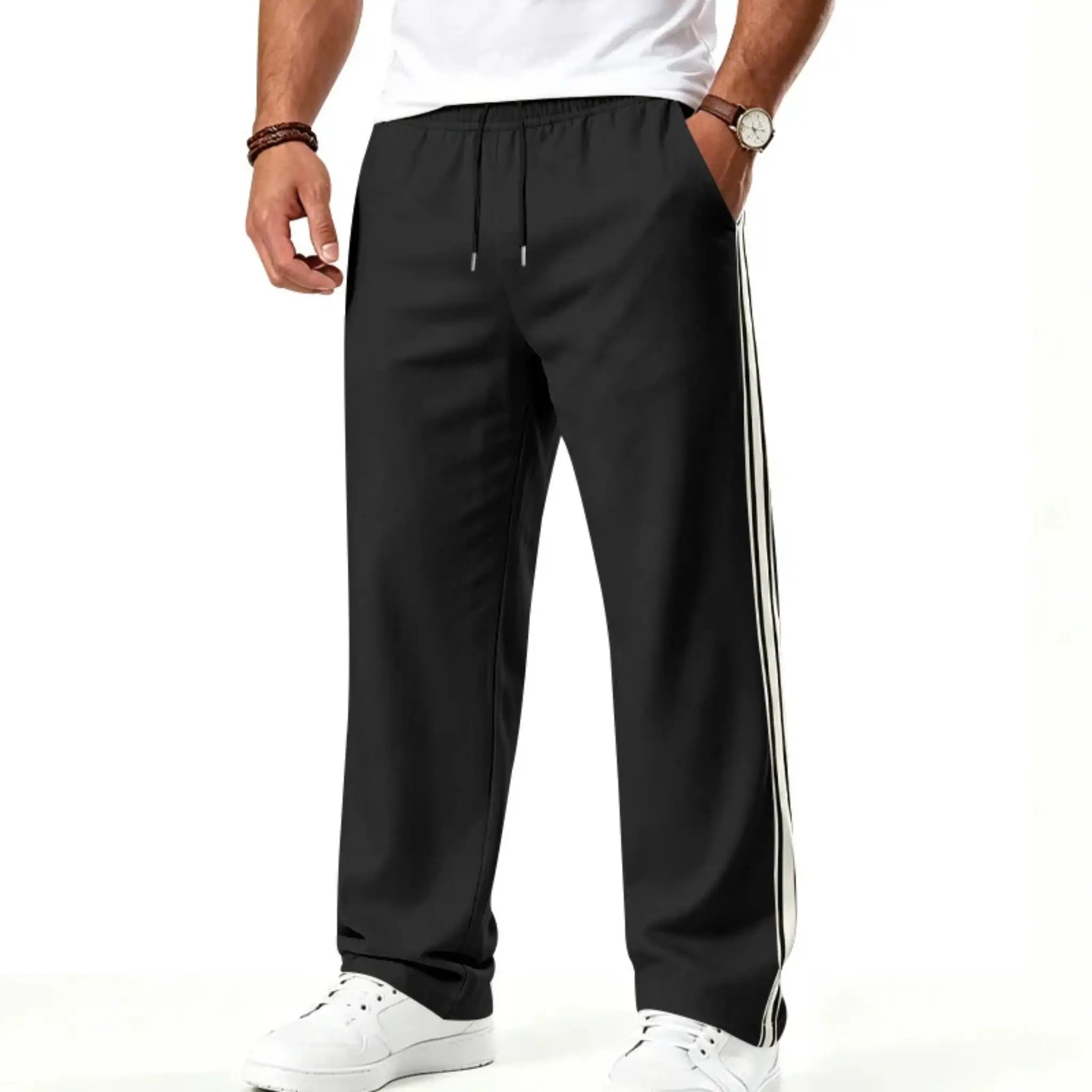 Man wearing MannerCo black color-block drawstring jogger pants with contrast tape detail, front view