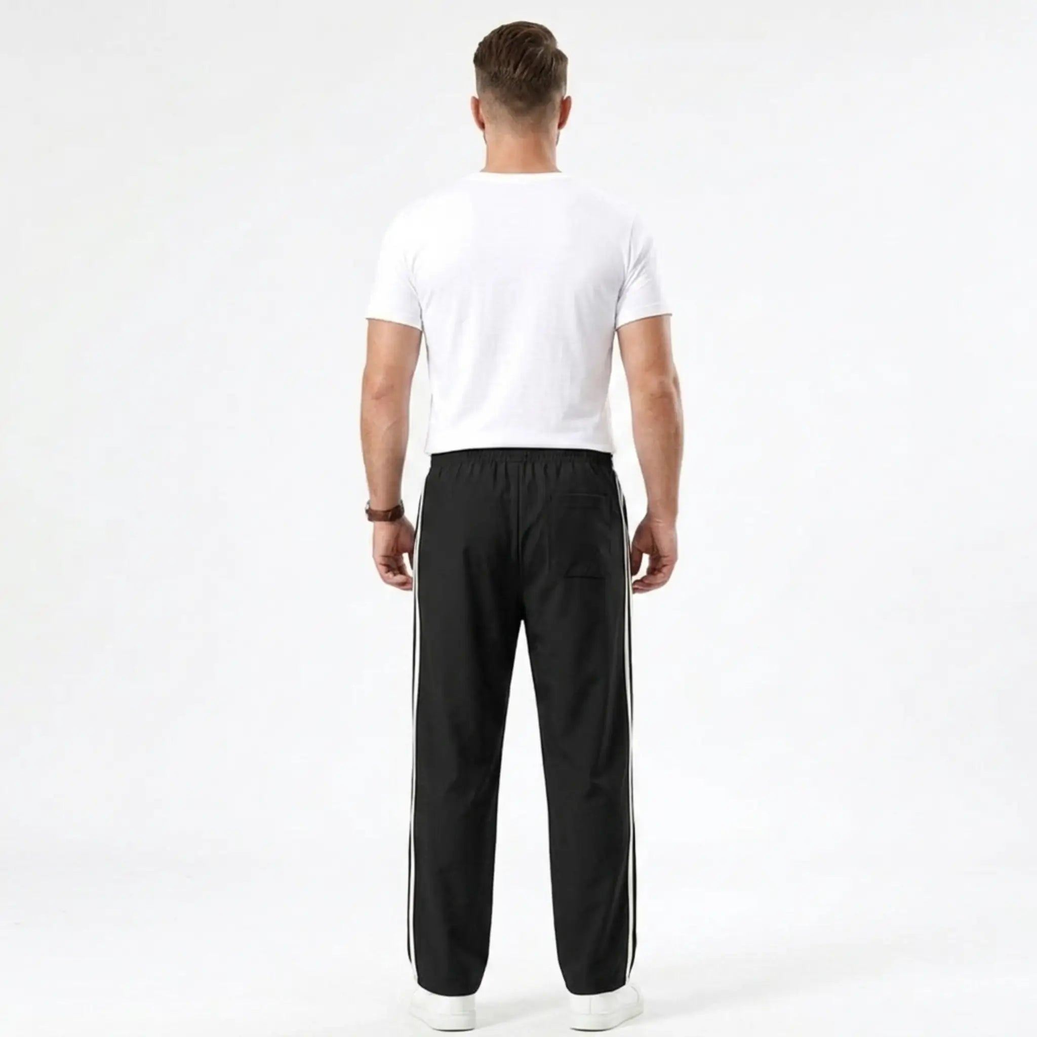 Man wearing MannerCo black color-block drawstring jogger pants in outdoor lifestyle setting