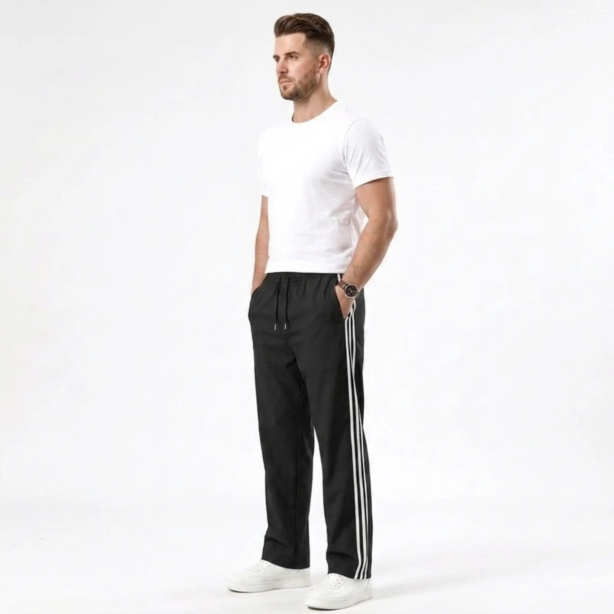 Man wearing MannerCo black color-block drawstring jogger pants in outdoor lifestyle setting