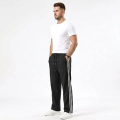 Man wearing MannerCo black color-block drawstring jogger pants in outdoor lifestyle setting