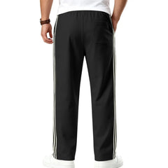 MannerCo black color-block jogger pants product display with contrast tape side detail