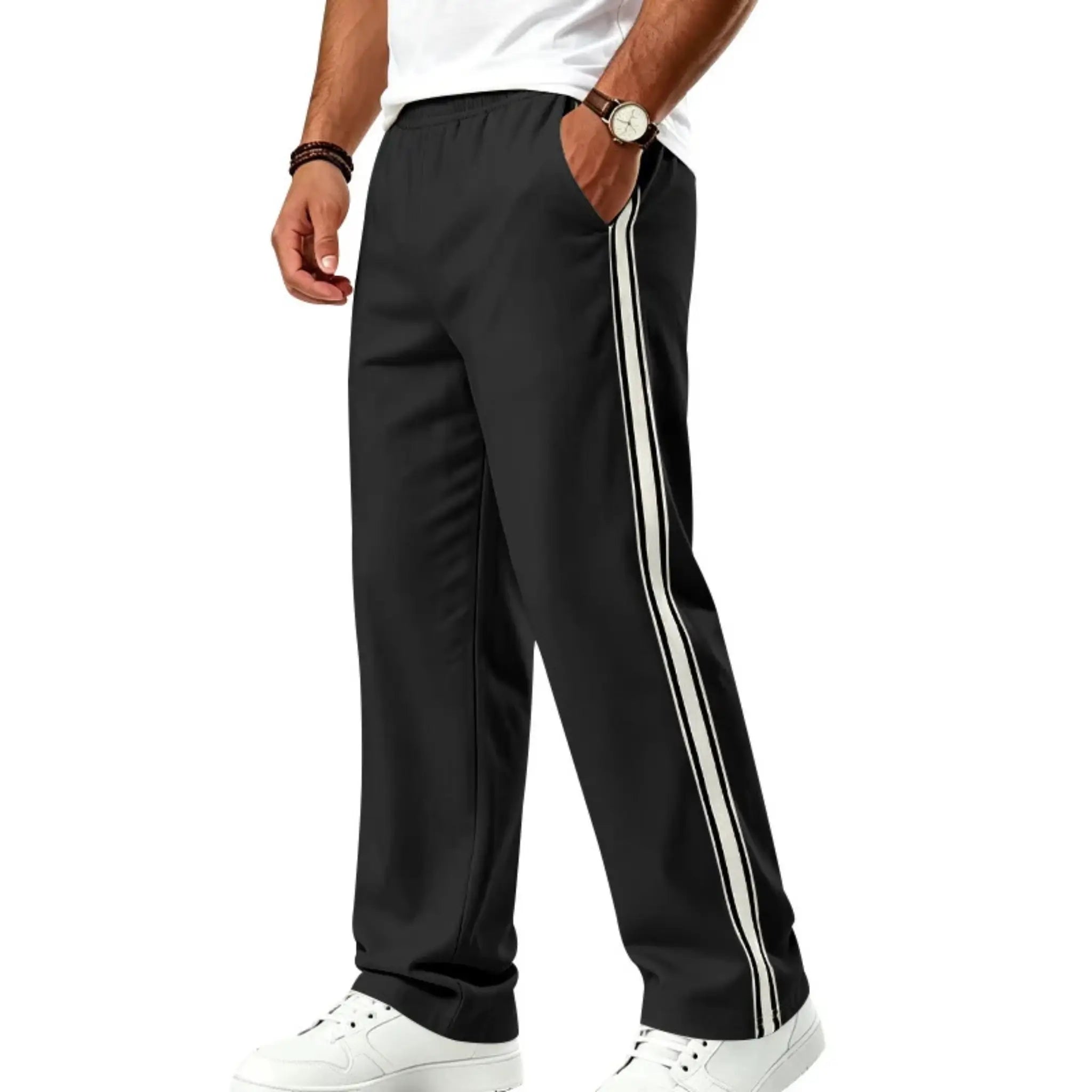 Man wearing MannerCo black color-block jogger pants with contrast tape detail, side view