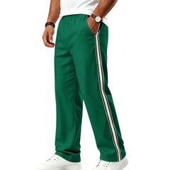 Man wearing MannerCo grass green color-block jogger pants with contrast tape detail, back view