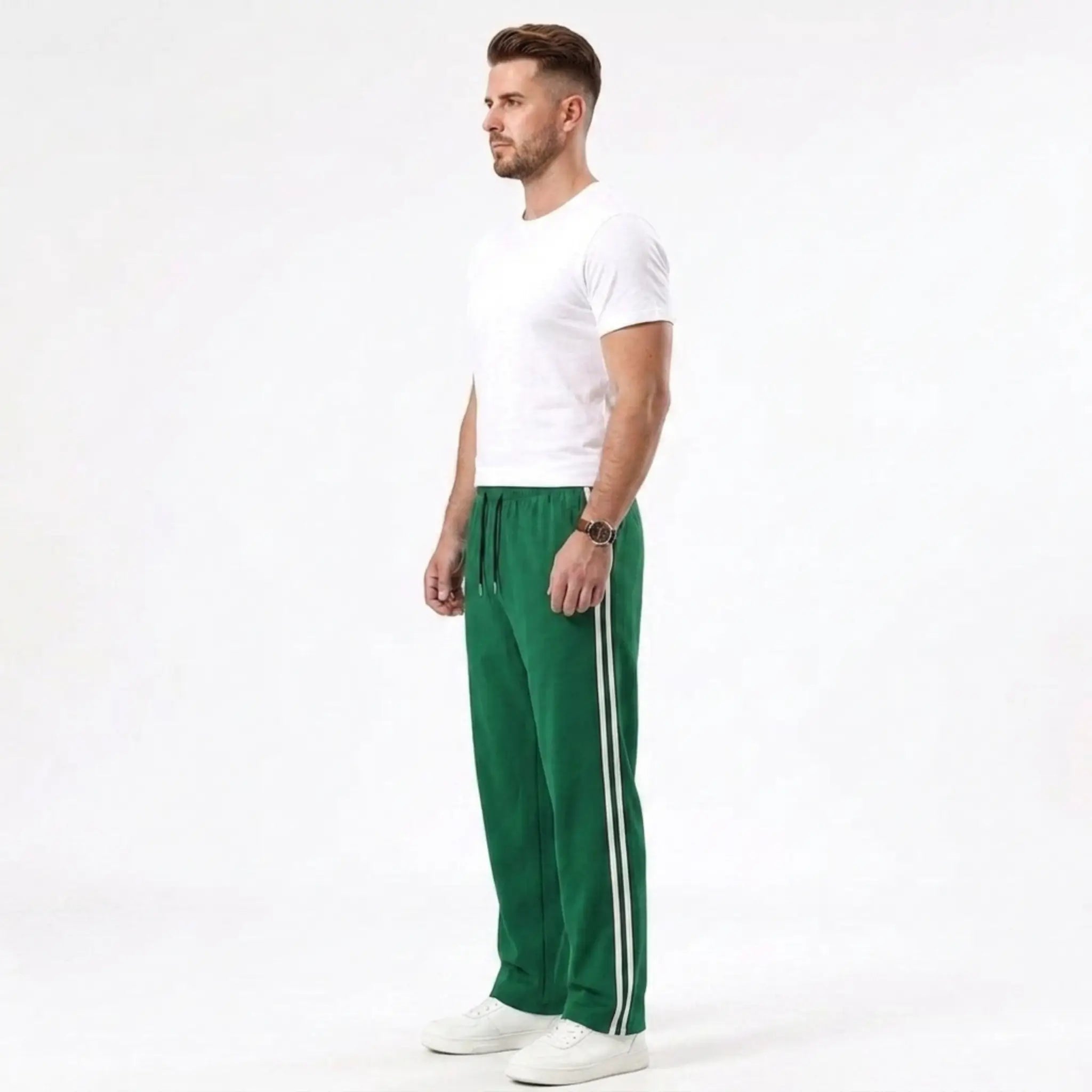 Man wearing MannerCo grass green color-block drawstring jogger pants in outdoor lifestyle setting