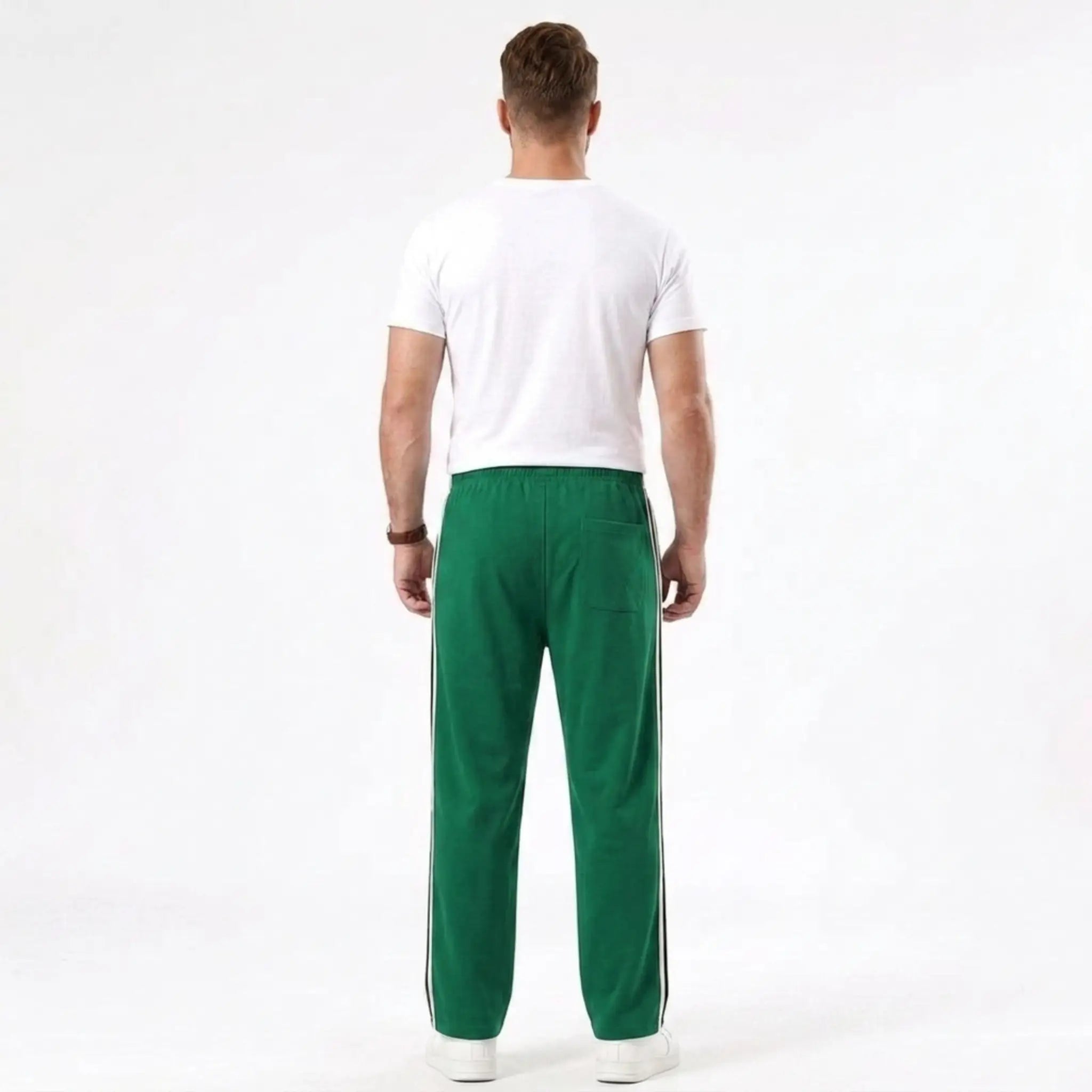 Man wearing MannerCo grass green color-block drawstring jogger pants in outdoor lifestyle setting