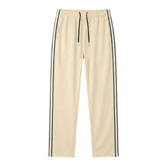 Man wearing MannerCo khaki color-block drawstring jogger pants with contrast tape detail, back view