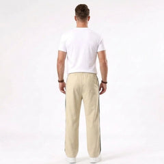 Man wearing MannerCo khaki color-block drawstring jogger pants in outdoor lifestyle setting