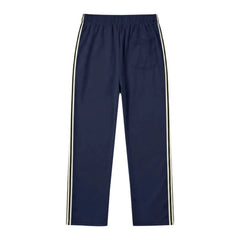 Man wearing MannerCo navy blue color-block drawstring jogger pants, back view on plain background
