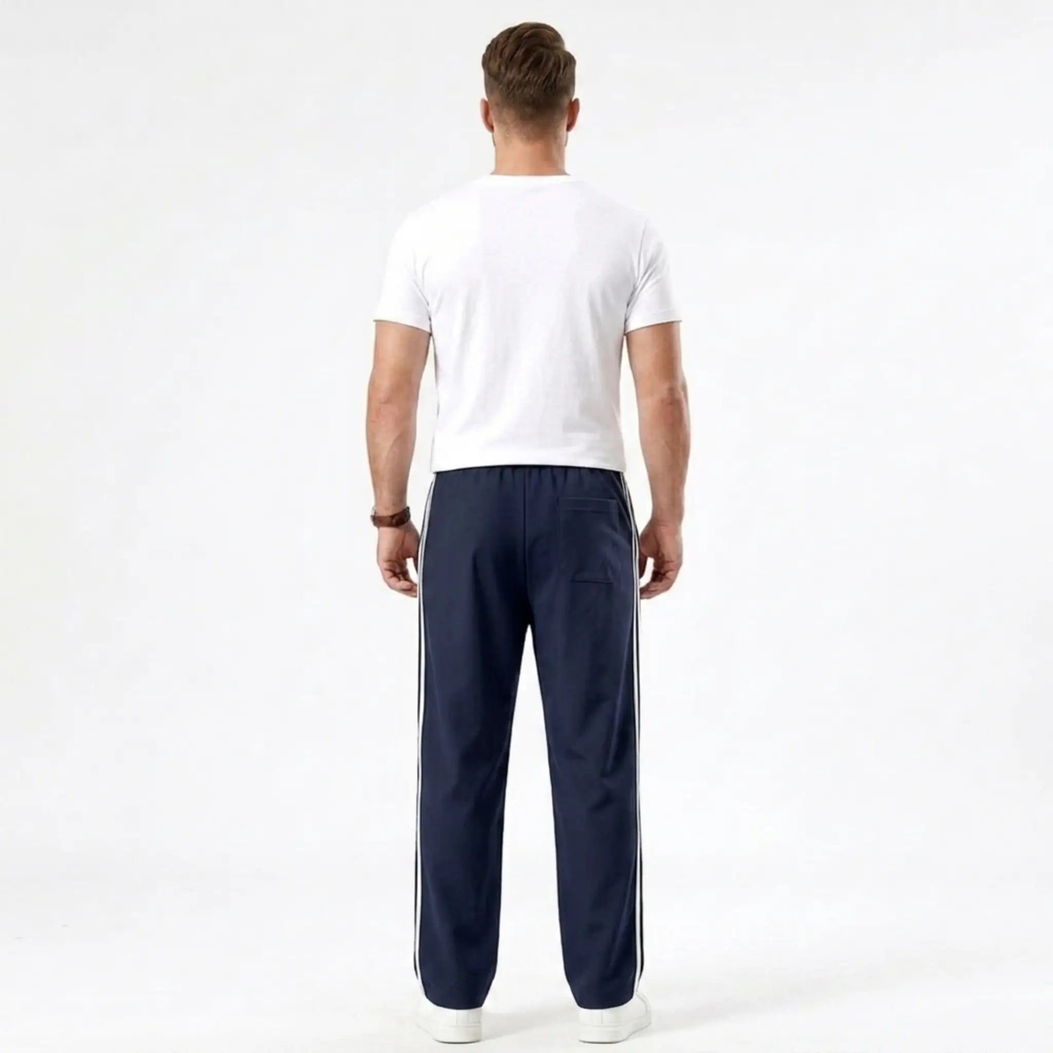 Man wearing MannerCo navy blue color-block jogger pants in outdoor lifestyle setting