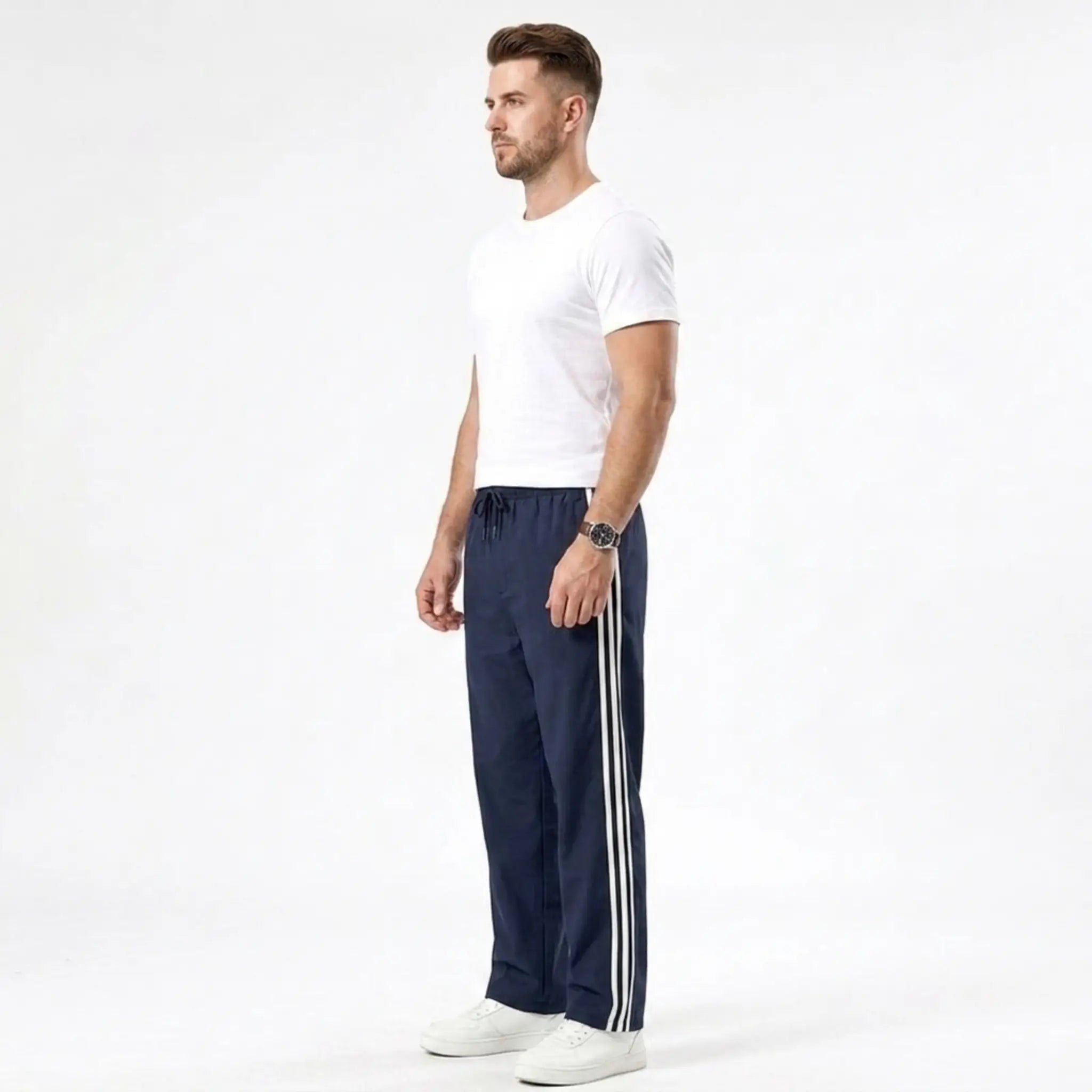 Man wearing MannerCo navy blue color-block drawstring jogger pants in outdoor lifestyle setting