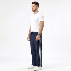 Man wearing MannerCo navy blue color-block drawstring jogger pants in outdoor lifestyle setting