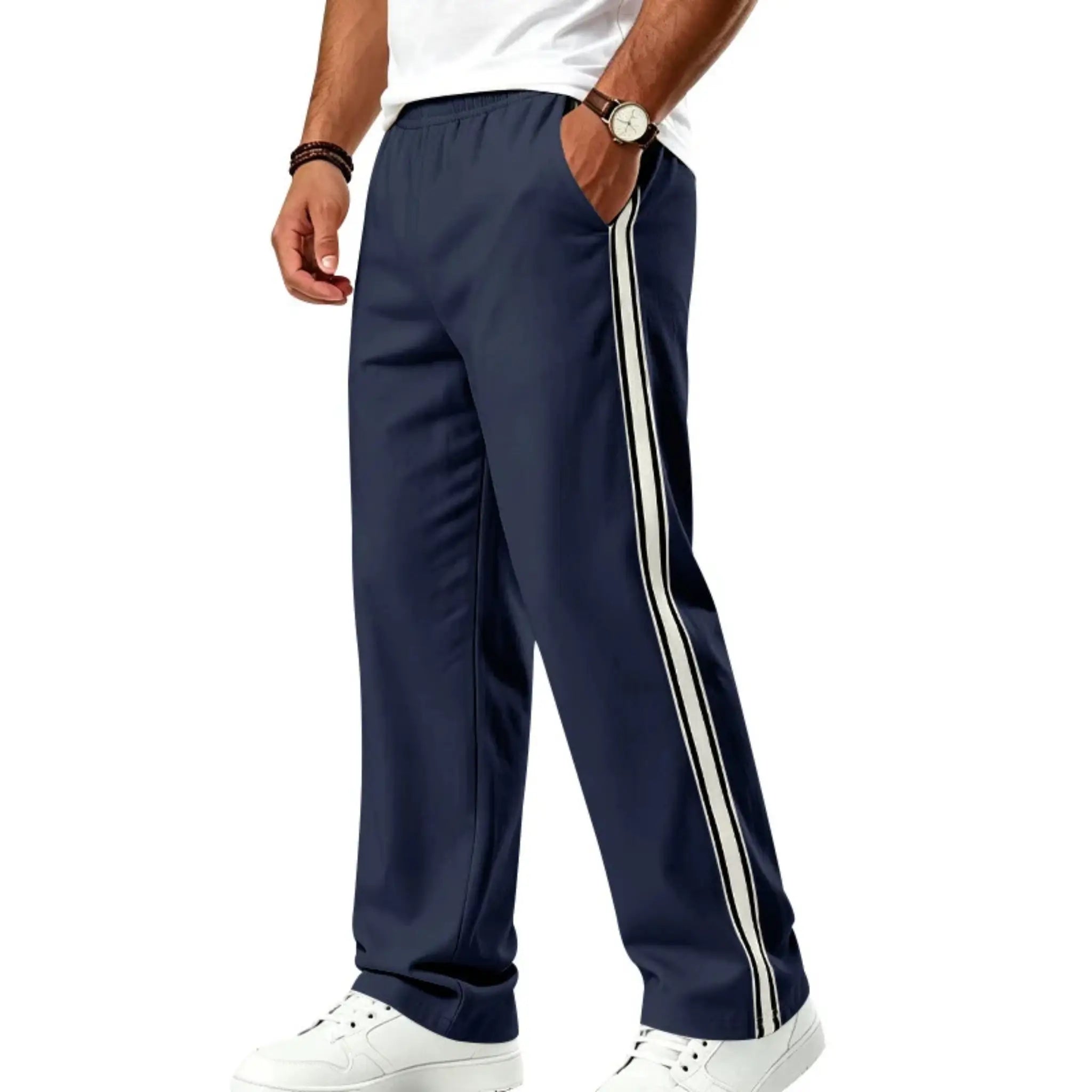 Man wearing MannerCo navy blue color-block jogger pants with contrast tape detail, side view