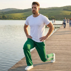 Man wearing MannerCo wine red color-block drawstring jogger pants with contrast tape detail, front view