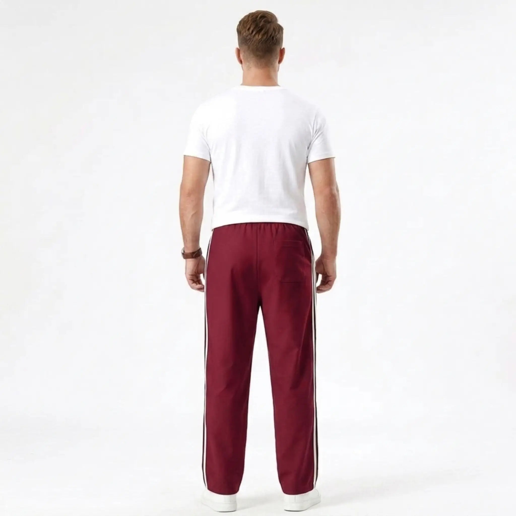 Man wearing MannerCo wine red color-block drawstring jogger pants in outdoor lifestyle setting