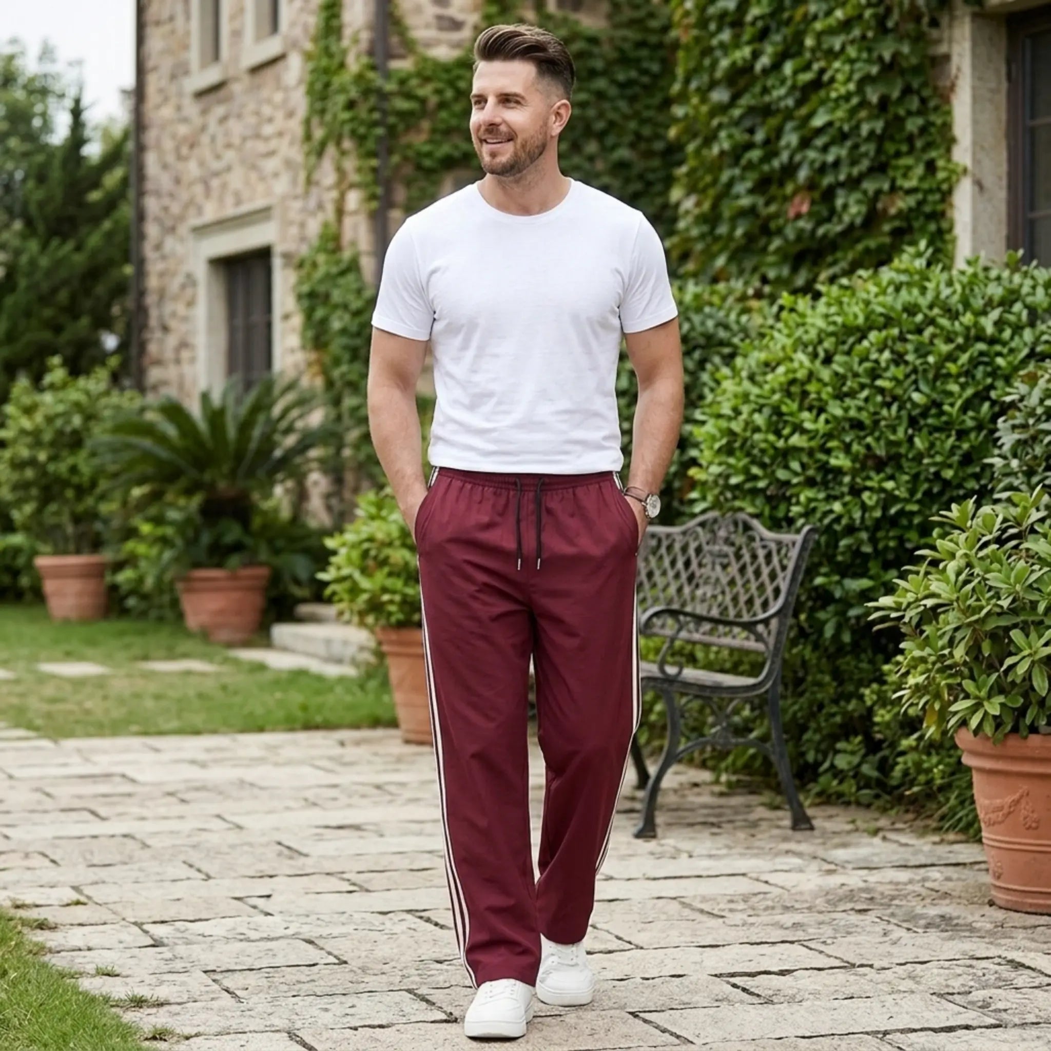 Man wearing MannerCo wine red color-block drawstring jogger pants in outdoor lifestyle setting