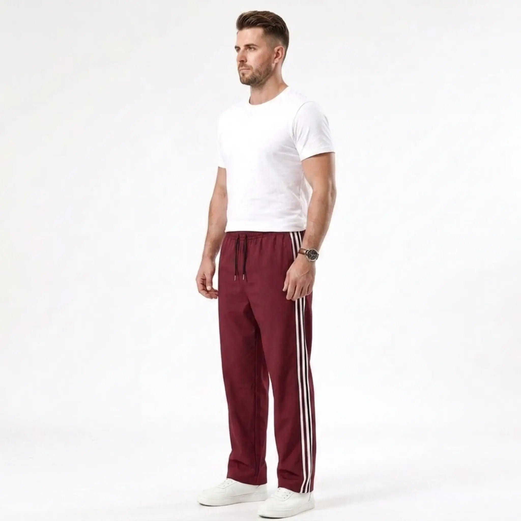 Man wearing MannerCo wine red color-block drawstring jogger pants in outdoor lifestyle setting