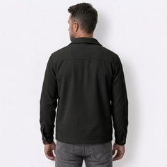 Man wearing MannerCo black corduroy single-breasted lapel jacket in outdoor lifestyle setting