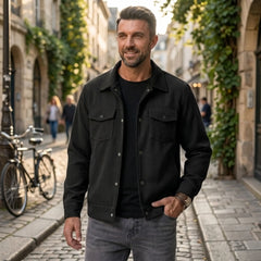 Man wearing MannerCo black corduroy single-breasted lapel jacket in outdoor lifestyle setting