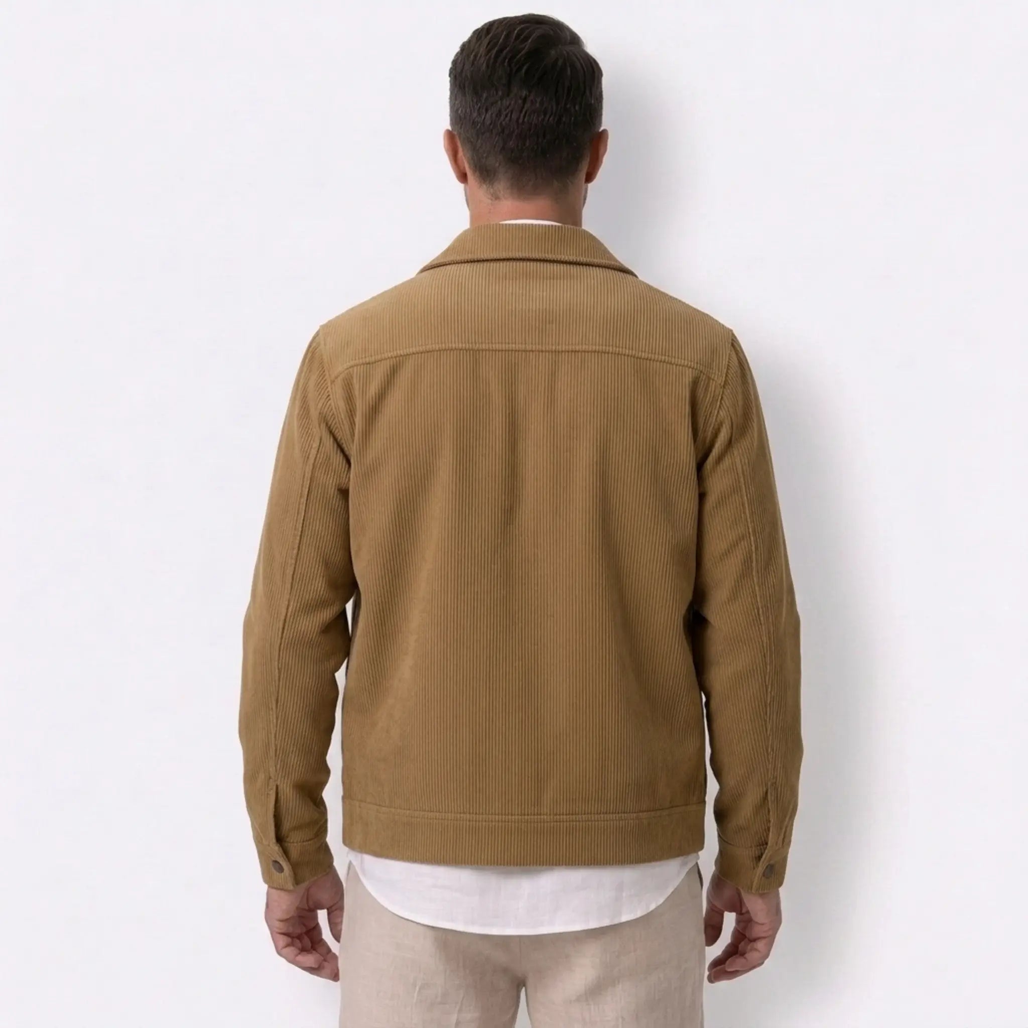Man wearing MannerCo black corduroy lapel jacket in outdoor lifestyle setting