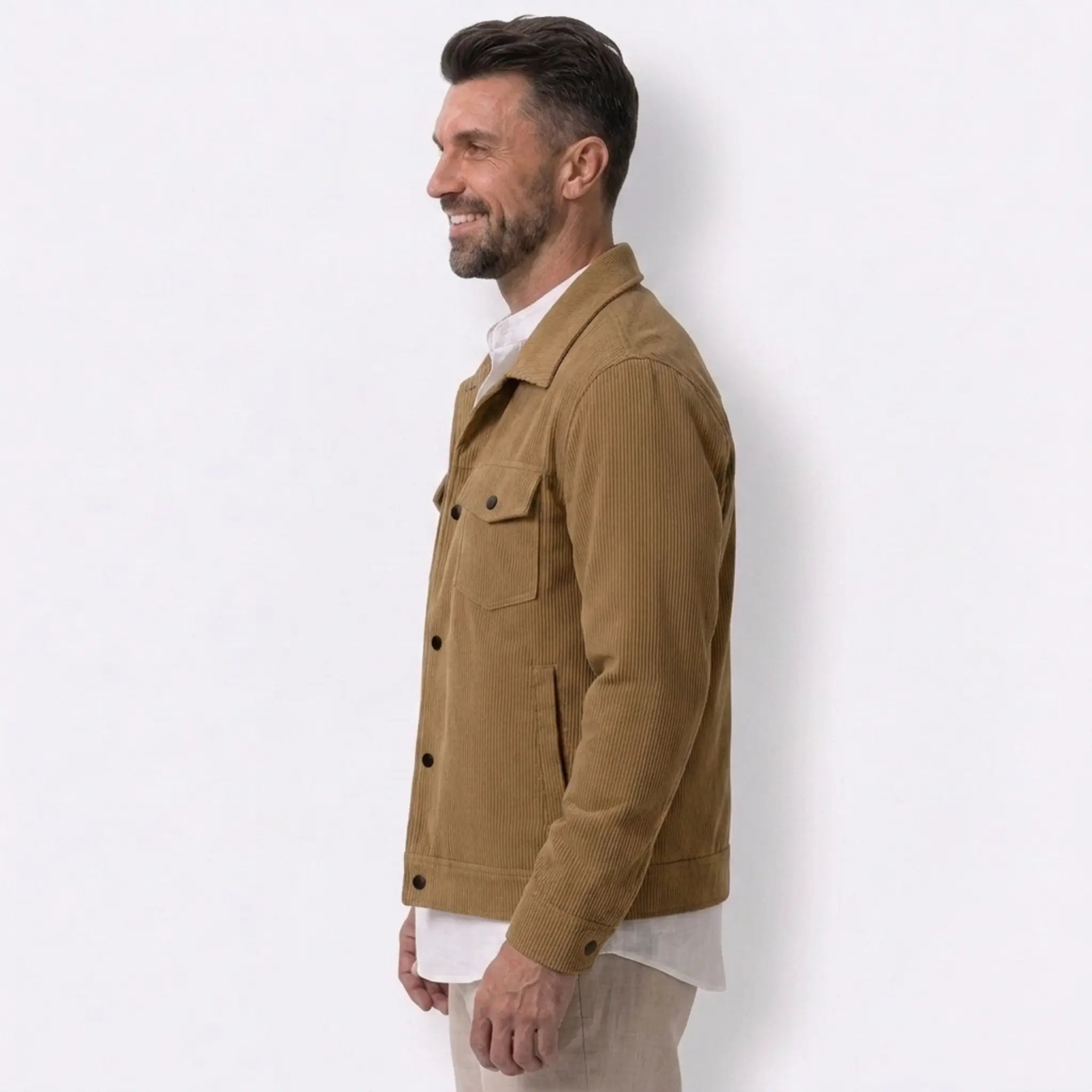 Man wearing MannerCo black corduroy single-breasted lapel jacket, side view on plain background