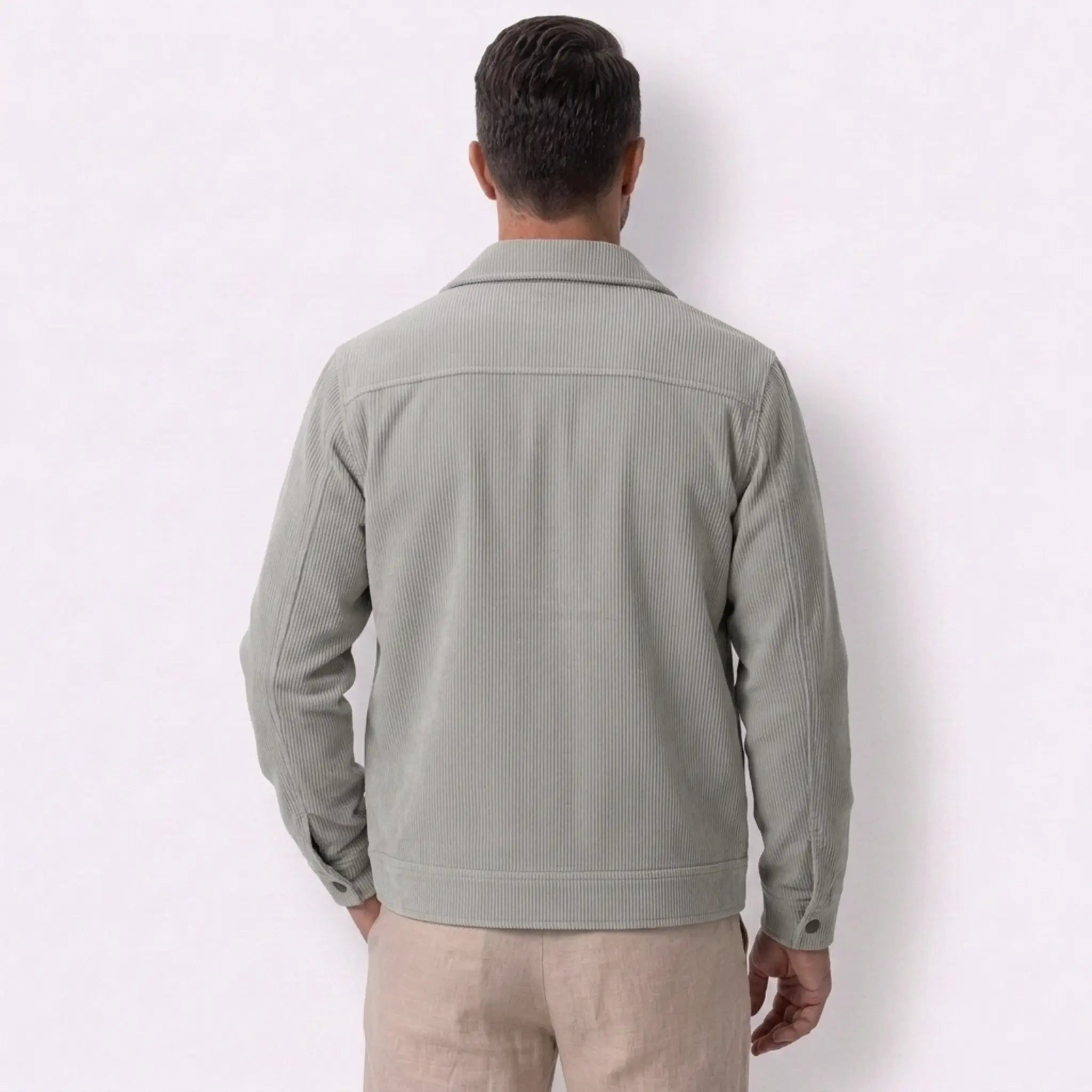 Man wearing MannerCo light gray corduroy lapel jacket in outdoor lifestyle setting