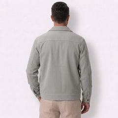 Man wearing MannerCo light gray corduroy lapel jacket in outdoor lifestyle setting