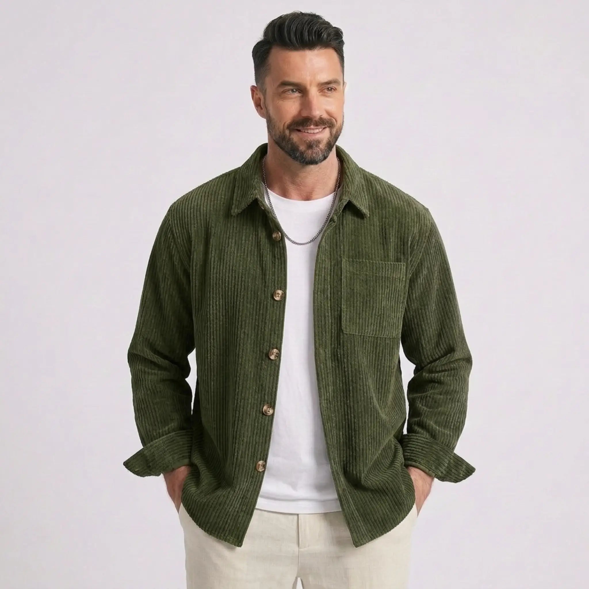 Man wearing MannerCo green corduroy long sleeve shirt with flip collar, front view on plain background
