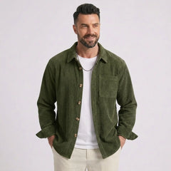 Man wearing MannerCo green corduroy long sleeve shirt with flip collar, front view on plain background