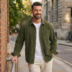 Man wearing MannerCo green corduroy long sleeve shirt in outdoor lifestyle setting