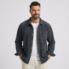 Man wearing MannerCo grey blue corduroy long sleeve shirt with flip collar, front view on plain background