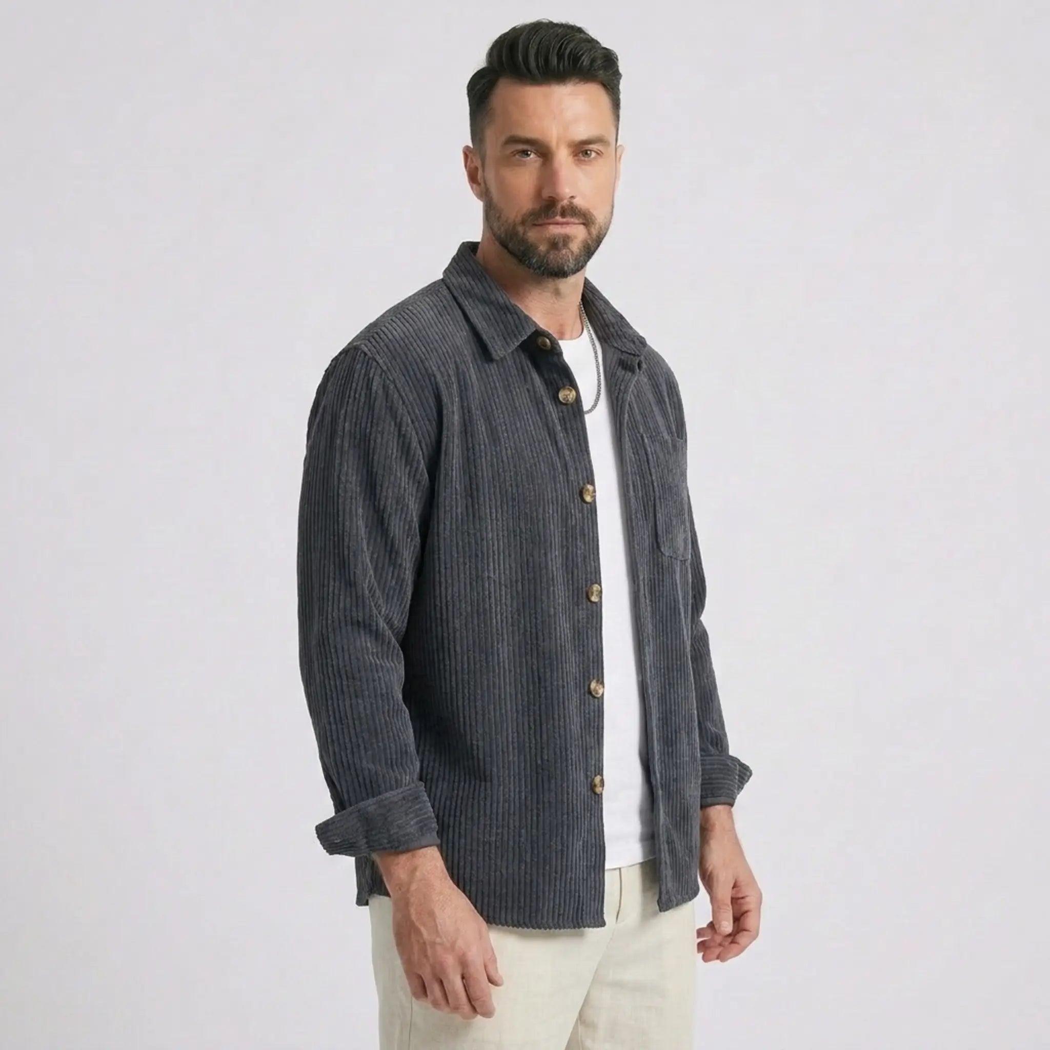 Man wearing MannerCo grey blue corduroy long sleeve shirt with flip collar, front view on plain background