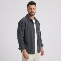 Man wearing MannerCo grey blue corduroy long sleeve shirt with flip collar, front view on plain background