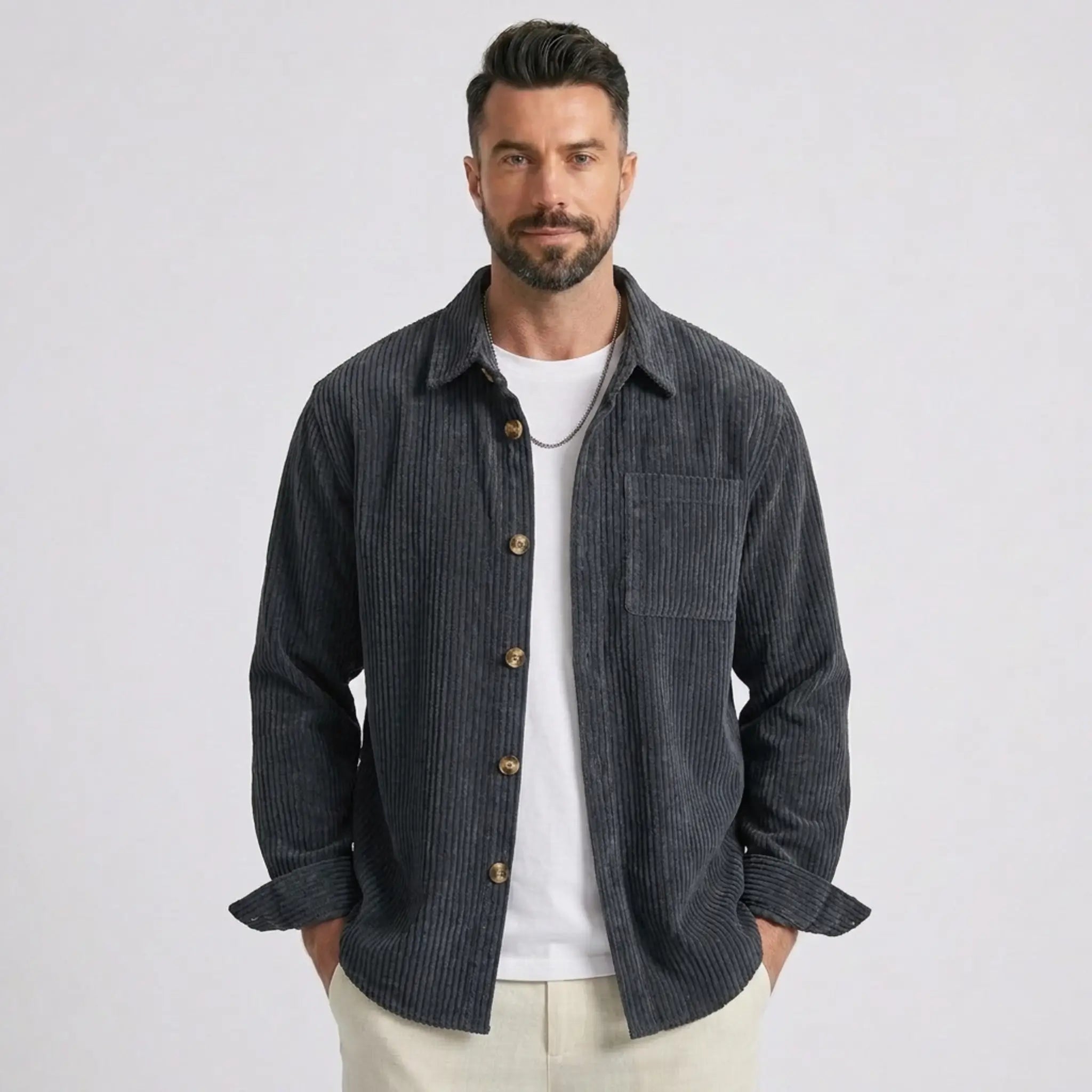 Man wearing MannerCo grey blue corduroy long sleeve shirt with flip collar, front view on plain background