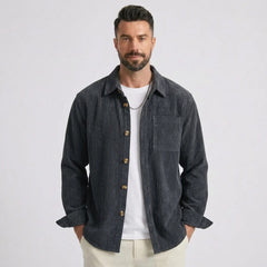 Man wearing MannerCo grey blue corduroy long sleeve shirt with flip collar, front view on plain background