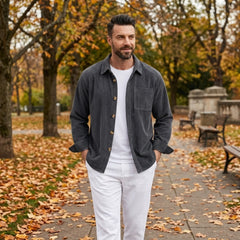 Man wearing MannerCo grey blue corduroy long sleeve shirt in outdoor lifestyle setting